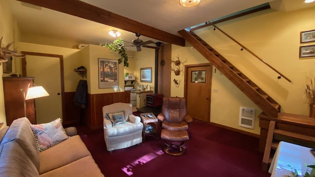 132 Little Mountain Rd, Whitefish, MT 59937 - living area featuring heating unit, beamed ceiling, a ceiling fan, stairs, and a wood stove
