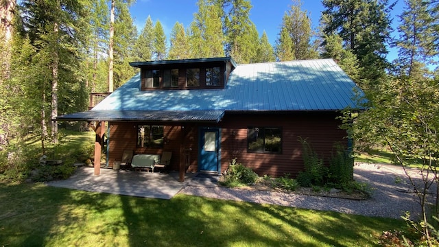 132 Little Mountain Rd, Whitefish, MT 59937 - rear view of property with a yard, a patio area, and metal roof