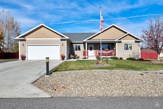 ranch-style house featuring a front lawn, covered porch, and a garage