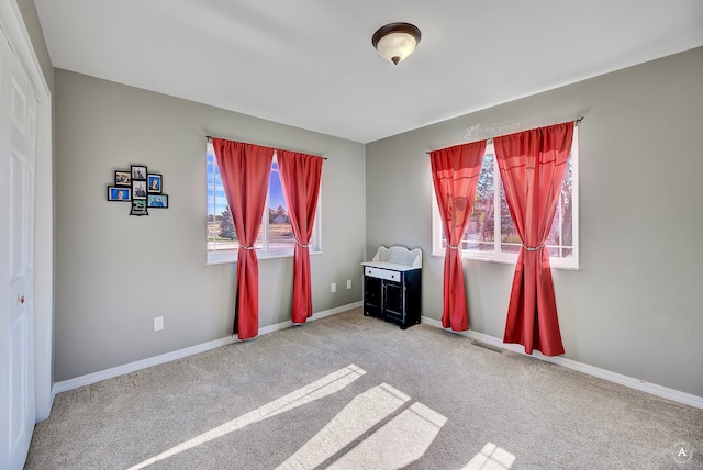 unfurnished room featuring carpet flooring