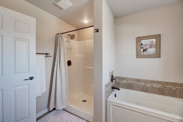 bathroom featuring independent shower and bath