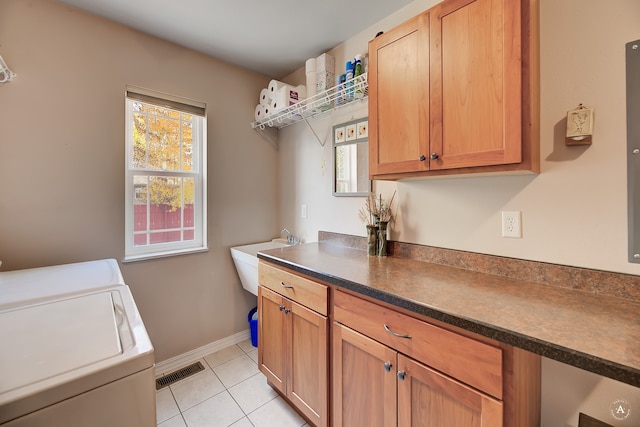 laundry room with cabinets, washer and dryer, and light tile patterned flooring