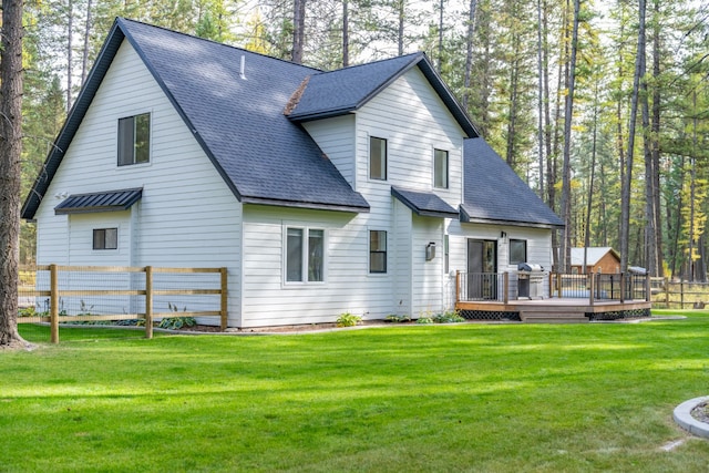 back of house with a yard and a wooden deck