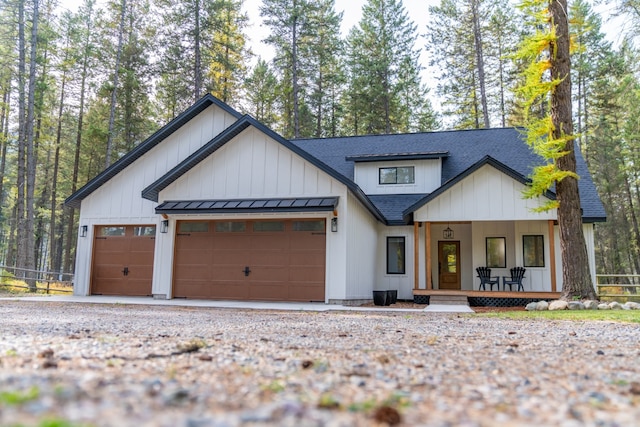 modern farmhouse with a porch and a garage