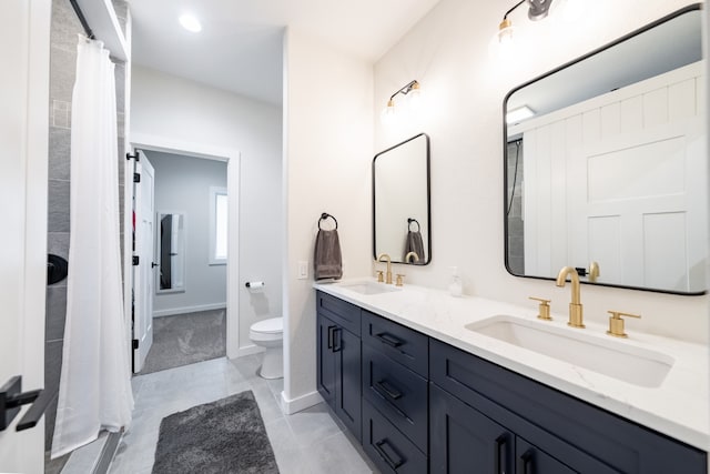 bathroom with toilet, curtained shower, vanity, and tile patterned floors