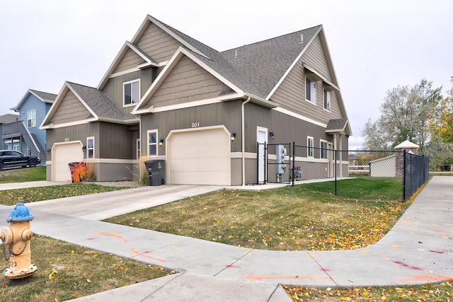 craftsman-style home featuring a front yard and a garage