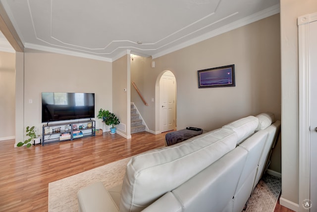 living room with ornamental molding and wood-type flooring