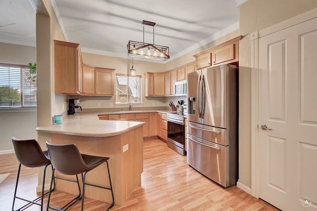 kitchen featuring light brown cabinets, kitchen peninsula, hanging light fixtures, a wealth of natural light, and stainless steel appliances