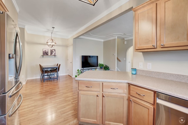 kitchen featuring light brown cabinetry, appliances with stainless steel finishes, light hardwood / wood-style flooring, and decorative light fixtures