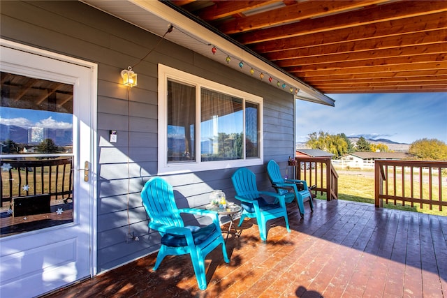 wooden deck with a mountain view