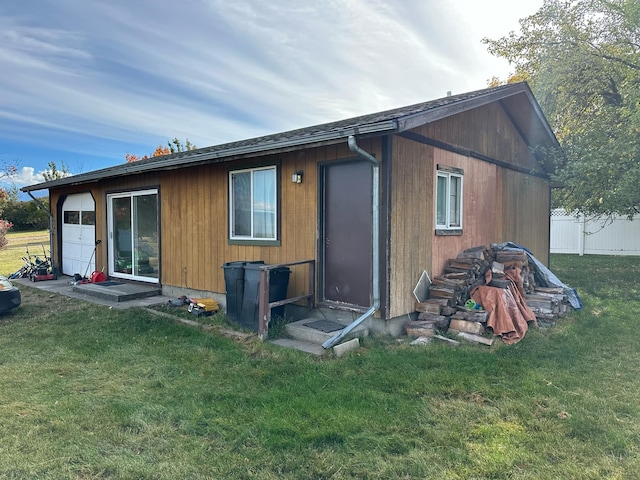 rear view of property with a lawn