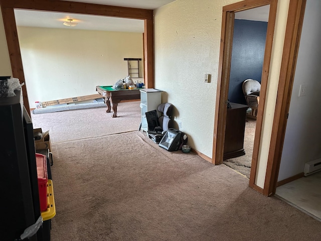corridor with a textured wall and carpet flooring