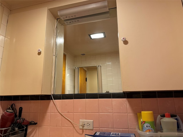 bathroom with tile walls and backsplash