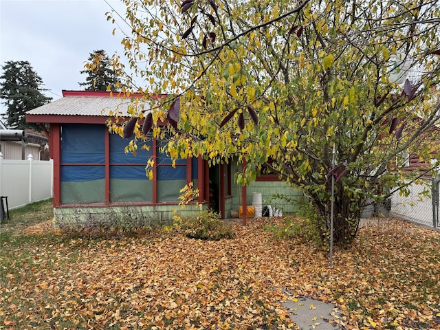 view of side of property featuring a sunroom