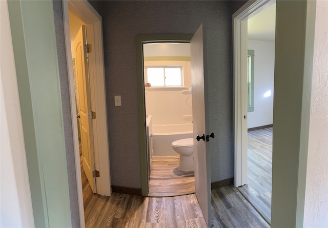 bathroom featuring wood-type flooring and toilet