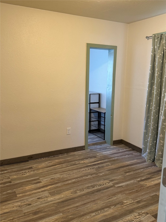 spare room with dark hardwood / wood-style floors