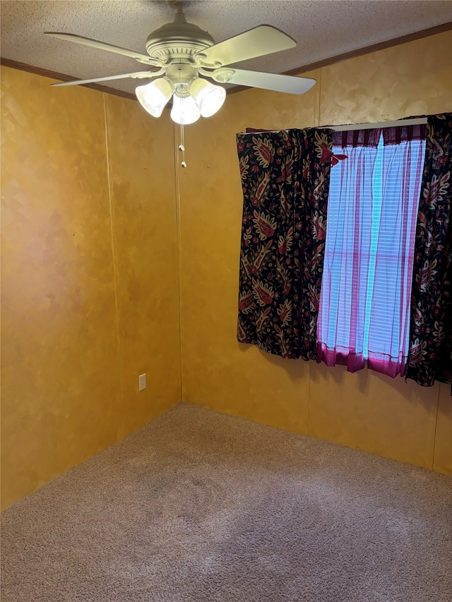 spare room with a textured ceiling, carpet, and ceiling fan