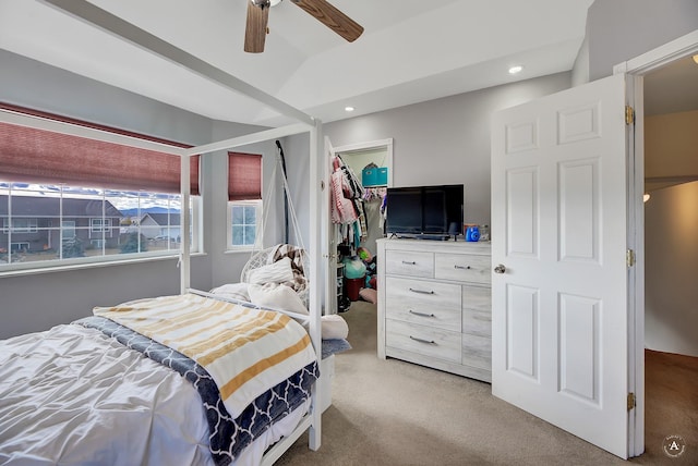 carpeted bedroom with ceiling fan, a spacious closet, and a closet