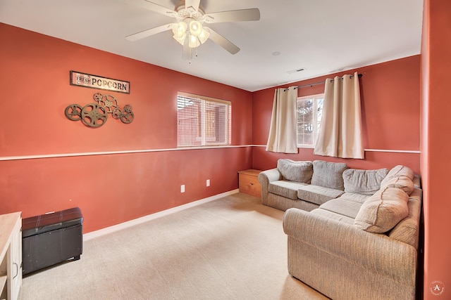 carpeted living room featuring ceiling fan