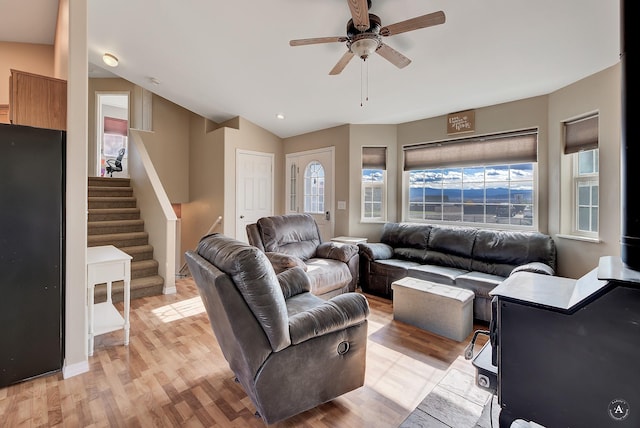 890 Antares Rd, Helena, MT 59602 - living area featuring light wood-type flooring, ceiling fan, stairway, and vaulted ceiling