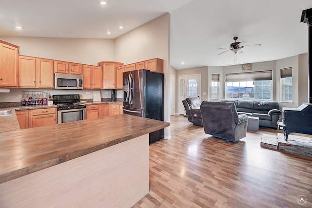 890 Antares Rd, Helena, MT 59602 - kitchen featuring stainless steel microwave, stove, refrigerator with ice dispenser, light brown cabinets, and butcher block counters