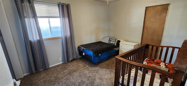 carpeted bedroom featuring a nursery area