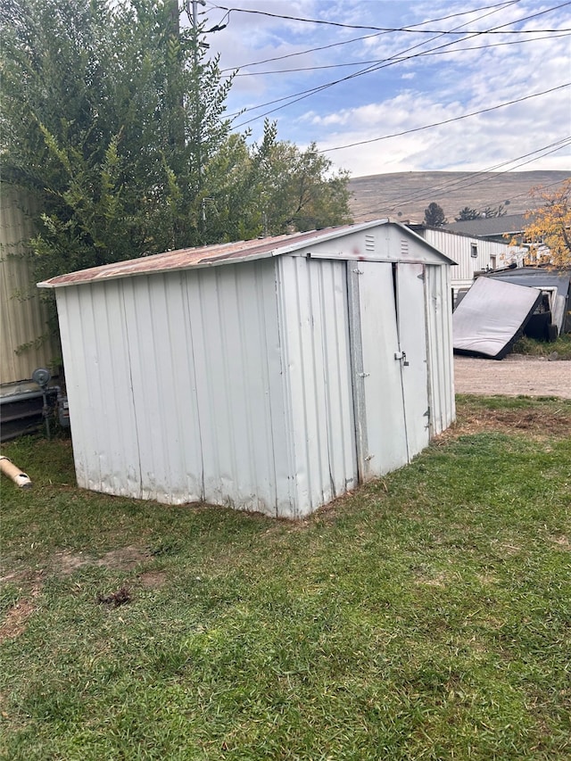 view of outbuilding with a lawn