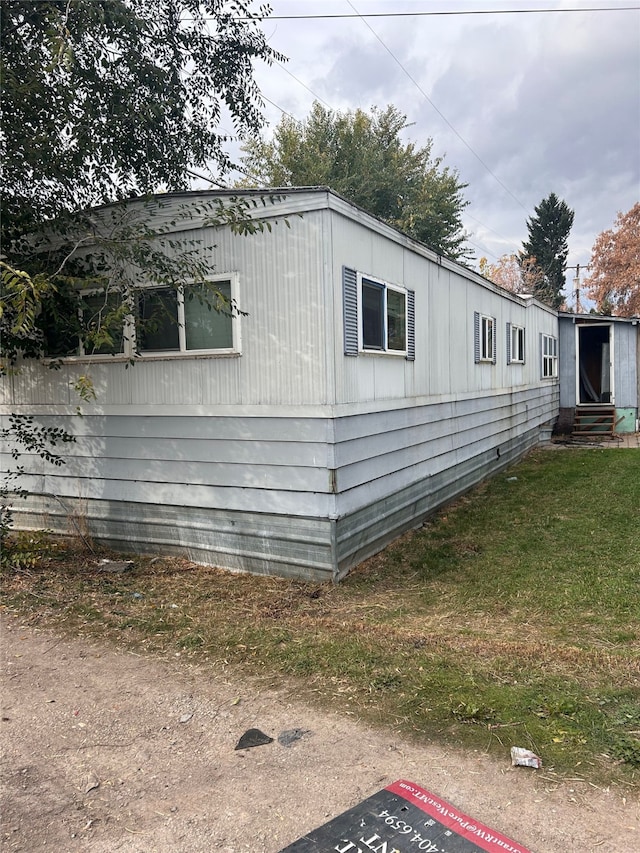 view of property exterior featuring a lawn