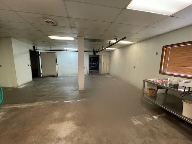 basement featuring a paneled ceiling