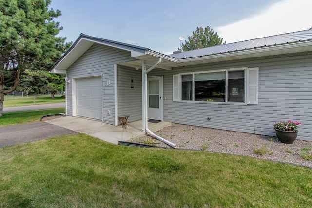 single story home with a front yard and a garage