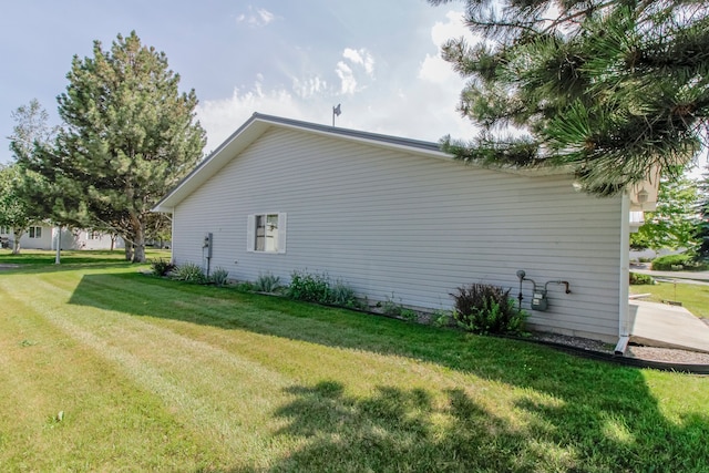 view of property exterior with a yard