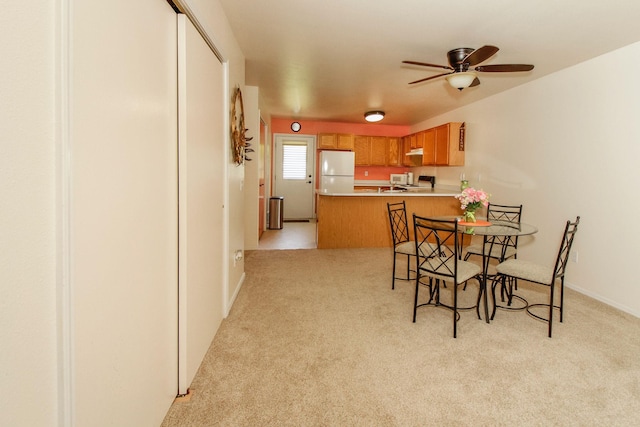 11 Iris Ct, Kalispell, MT 59901 - dining space with light colored carpet, a ceiling fan, and baseboards