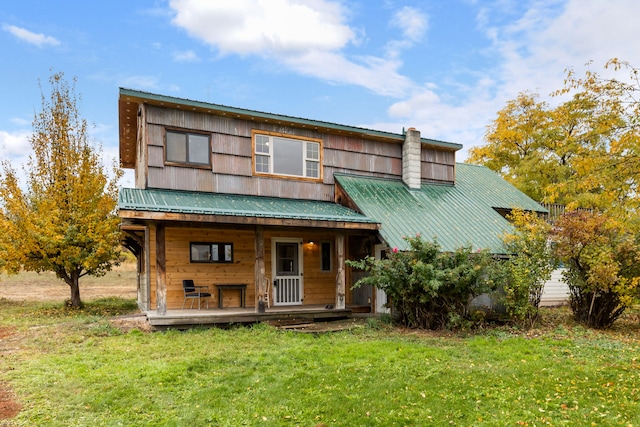 view of front of property with a front yard and covered porch