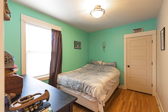 bedroom with hardwood / wood-style flooring