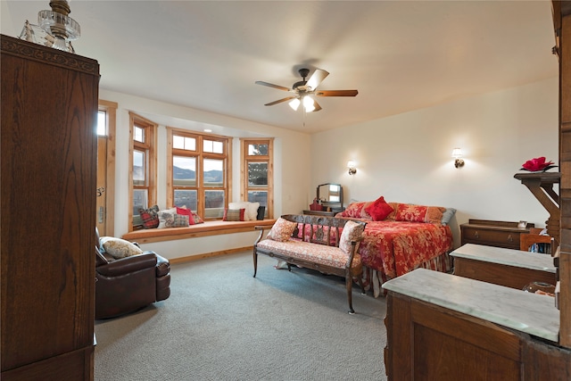 bedroom featuring light carpet and ceiling fan