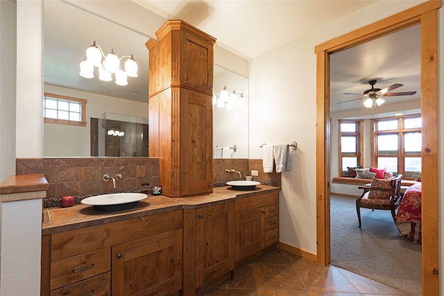 bathroom featuring vanity, tile patterned flooring, backsplash, and plenty of natural light