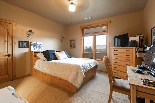 bedroom featuring ceiling fan and light carpet