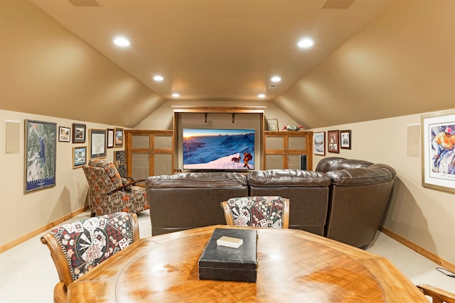 carpeted home theater featuring lofted ceiling