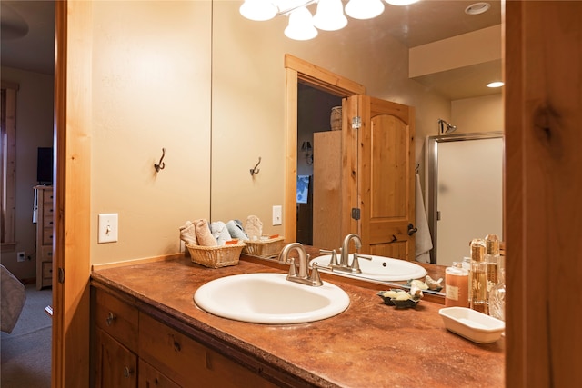 bathroom with vanity and a shower with shower door