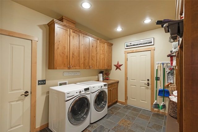 washroom featuring cabinets and washer and clothes dryer