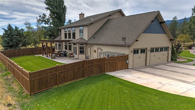 rear view of property with a yard and a garage