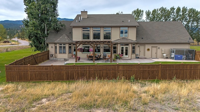 back of property with a patio and a mountain view