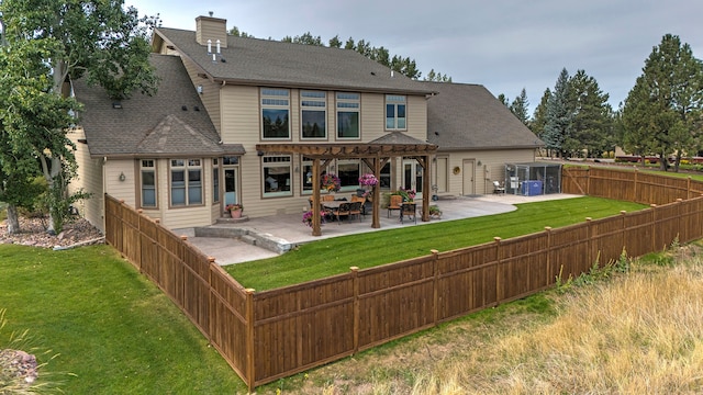 back of house with a patio area and a lawn