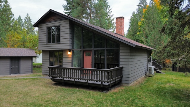 rear view of property featuring a lawn