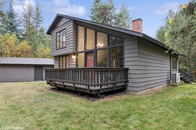 back of house with a yard and a deck