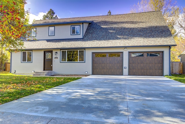 view of front facade with a front yard and a garage