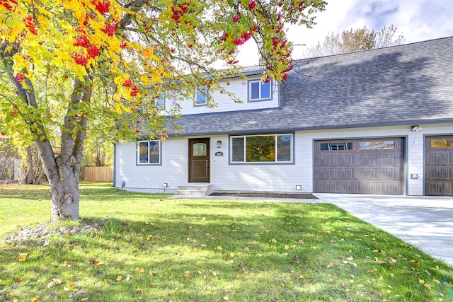 view of front of property with a garage and a front lawn