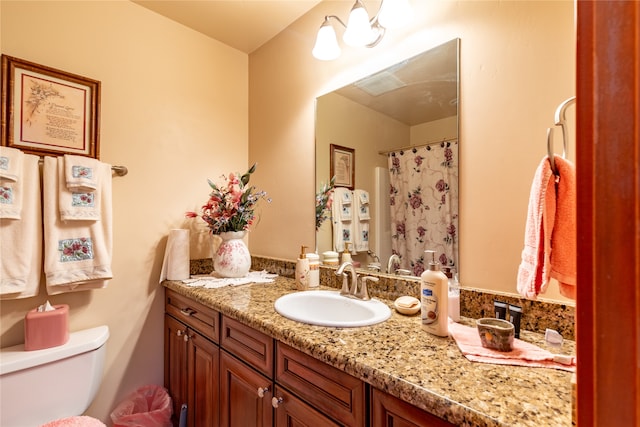 bathroom featuring toilet and vanity