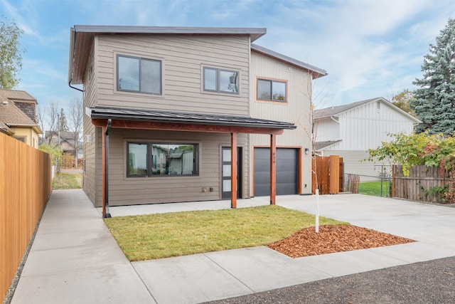 view of front facade with a front yard and a garage