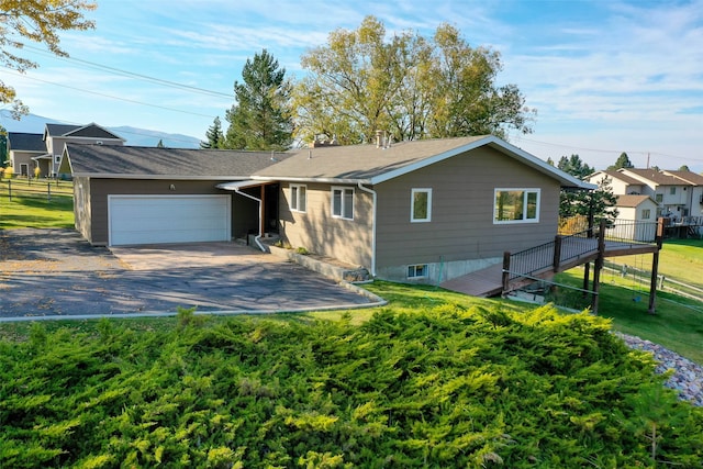 view of front of home with a garage and a front lawn